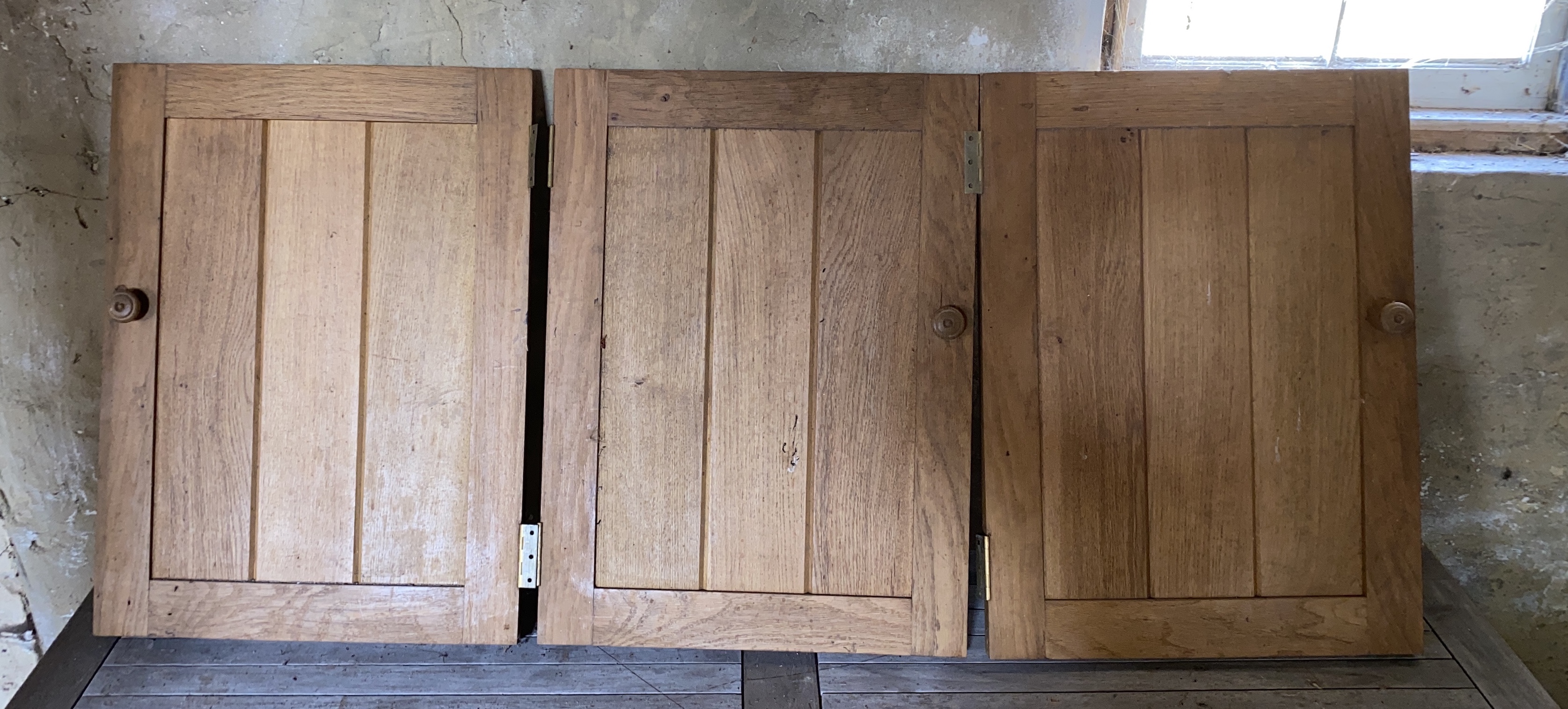 Six solid oak cupboard doors, consisting of three 72 x 52cm; one 73 x 63cm; one 82 x 63.5cm and another, with a canted side, 125 x 62.5cm